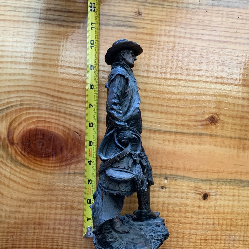 Western cowboy holding horse saddle statue - Picture 2 of 4